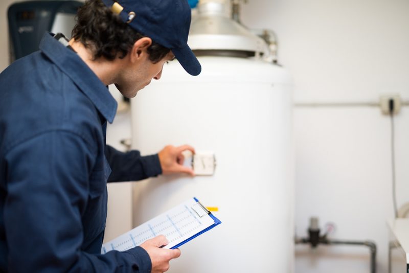 Technicial repairing a water heater